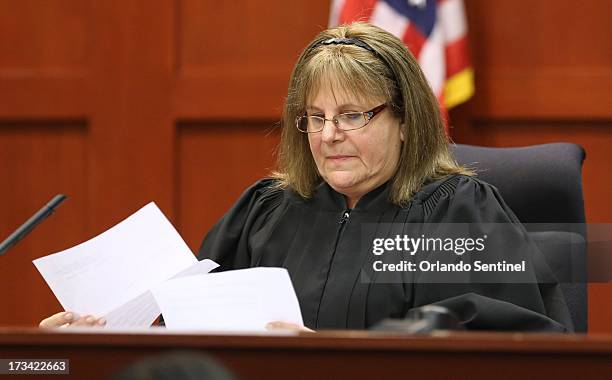 Judge Debra Nelson reads the verdict to herself before handing it to the clerk of courts in the trial of George Zimmerman at the Seminole County...