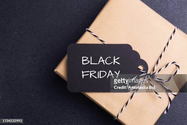 top view of gift box with black and white ribbon and black tag. black friday sale concept. - f��retag bildbanksfoton och bilder