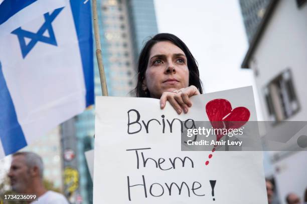 Woman holds a sign during a protest calling to bring back the hostages that were kidnaped last Saterday during Hamas' and Palestinan militants attack...