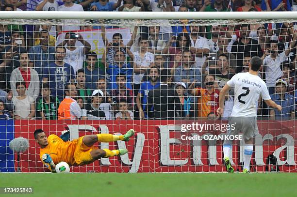 France's goalkeeper Alphonse Areola saves a penalty kick by Uruguay's Velazquez during the FIFA Under 20 World Cup final football match at Turk...