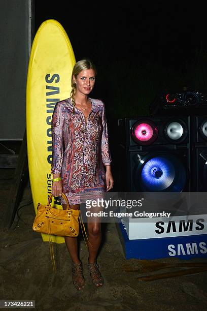 Nicky Hilton sizes up the brand new sound system from Samsung at their #GigaSoundBlast Summer DJ series at Surf Lodge on July 13, 2013 in Montauk,...