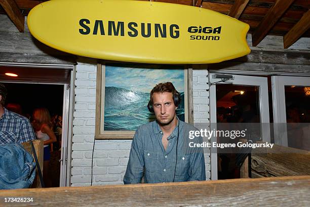 Brendan Fallis performs in the DJ booth during Samsung's Summer DJ Series to launch the Giga Sound System at Surf Lodge on July 13, 2013 in Montauk,...