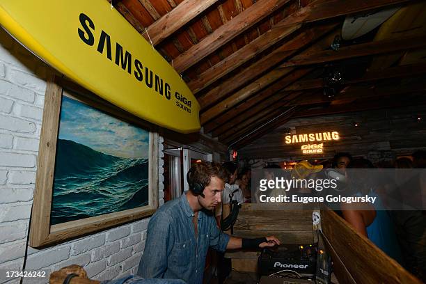 Brendan Fallis performs in the DJ booth during Samsung's Summer DJ Series to launch the Giga Sound System at Surf Lodge on July 13, 2013 in Montauk,...