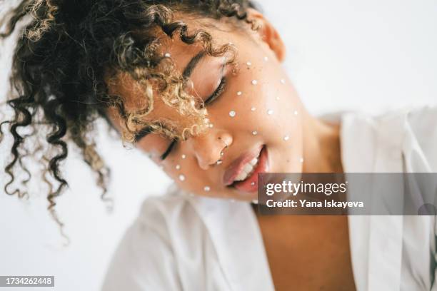 a beautiful woman enjoying the sunlight. concepts of self-care and self-love - rhinestone stock pictures, royalty-free photos & images