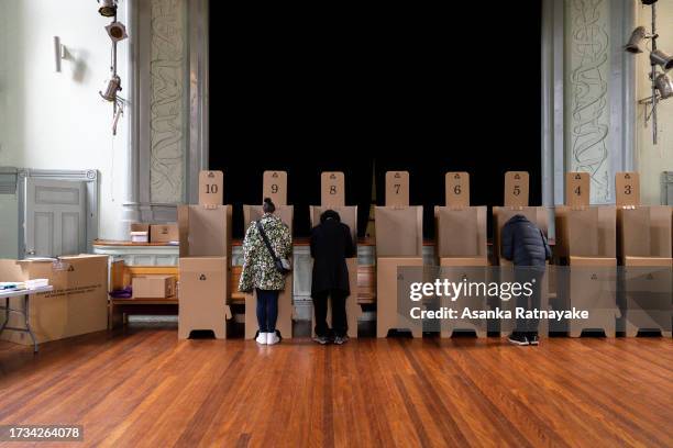 Voters at a polling box cast their vote at a polling centre on October 14, 2023 in Melbourne, Australia. A referendum for Australians to decide on an...