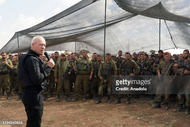 Israeli Defense Minister Yoav Gallant speaks during his visit to Israeli soldiers near the Gaza border as the clash between Israeli army and...