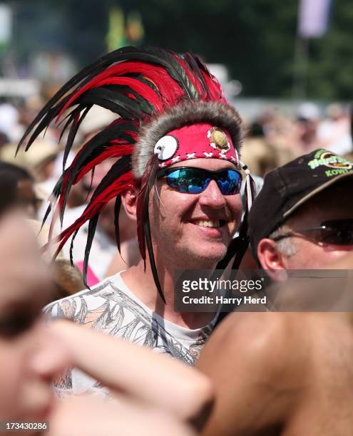 Fan waits for Jamiroquai to perform on stage at Magic Summer Live Festival 2013 at Stoke Park on July 13, 2013 in Guildford, England.
