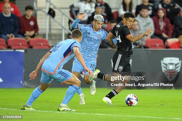 Andy Najar of D.C. United battles for the ball with Santiago Rodriguez of New York City FC and James Sands of New York City FC during a game between...