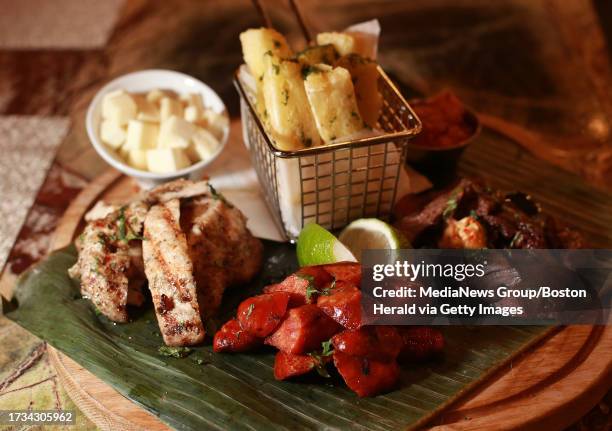 Parrillada, grilled chicken, skirt steak, chorizo manchego cheese, yuca fries, guasacaca and chimichurri at La Casa de Pedro, a new Seaport...