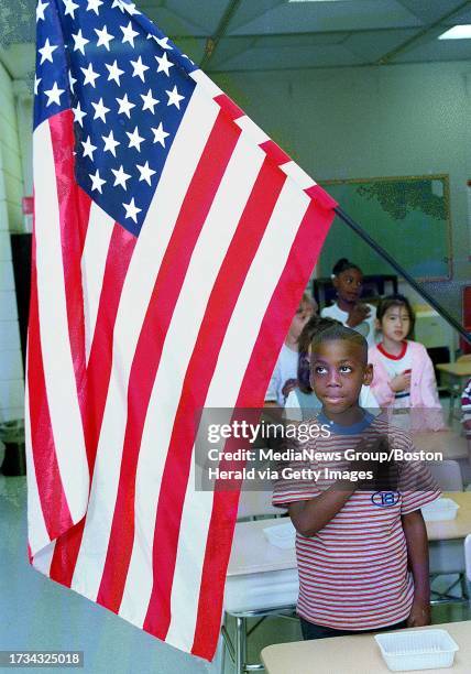 ISAIAH BRUCE 6, A FIRST GRADER IN MS. CONNOLLY'S CLASS AT THE QUINCY SCHOOL, RECITES THE PLEDGE OF ALLEGIANCE. STAFF PHOTO BY TED FITZGERALD PHOTO 4