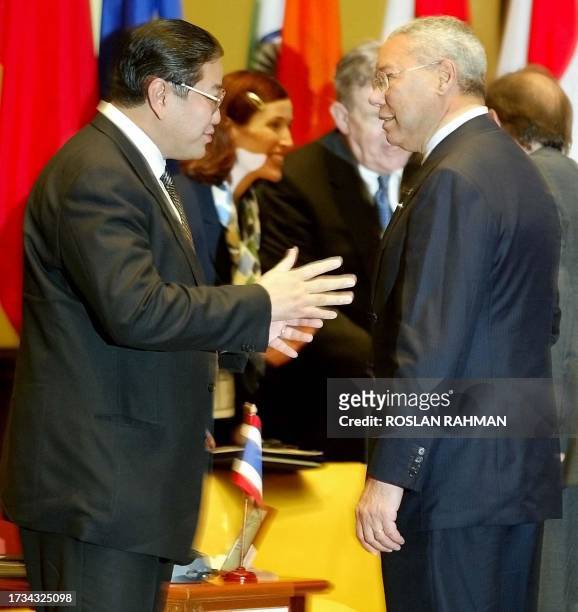 Indonesian Foreign Minister Hassan Wirayuda chats with US Secretary of State Collin Powell before the start of the 9th ASEAN Regional Forum meeting...