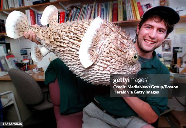 Vetrinary Lab Technician Craig Clark is all smiles while holding "PuffY" the stuffed puffer fish at The New England Aquarium9/16.staff photo:Patrick...