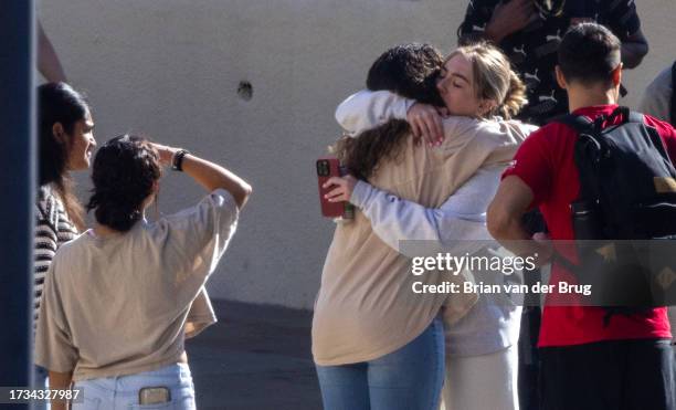 Malibu, CA Pepperdine University students embrace as students, faculty and greater campus community members make a somber procession into the...