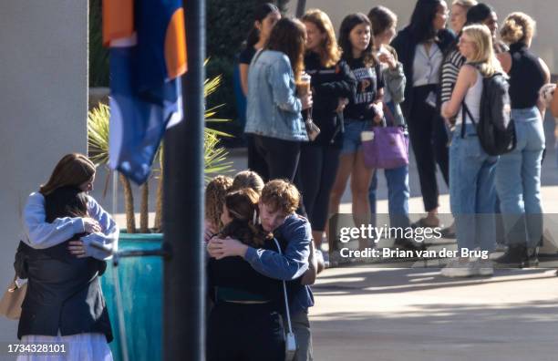 Malibu, CA Pepperdine University students embrace as students, faculty and greater campus community members make a somber procession into the...