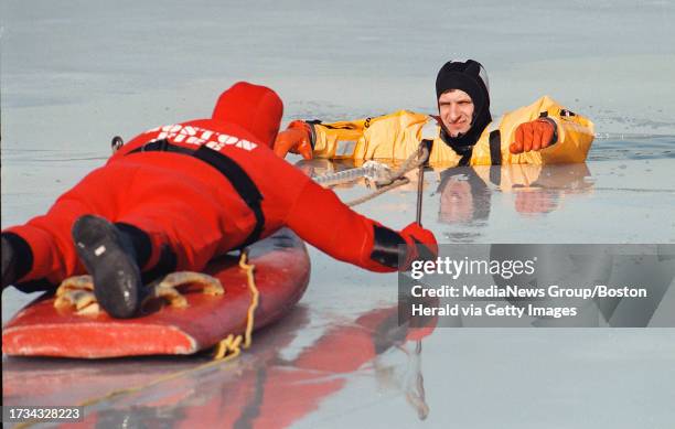 JAMAICA PLAIN, MA 1/21/99: BOSTON FIRE DEPT. TAKES PART IN AN ICE RESCUE DRILL AT JAMAICA POND. LT. ROBERT SANTANGELO MAKES HIS WAY TO 'VICTIM' CAPT....
