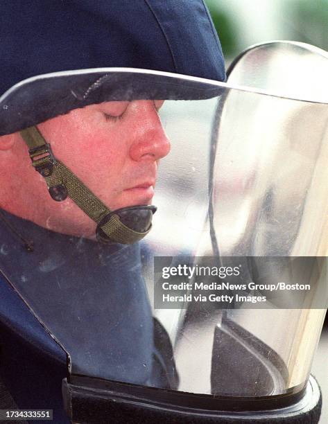 Officer Michael Kane concentrates before checking on a suspicious package in West Roxbury. STAFF PHOTO BY JON HILL saved in adv news