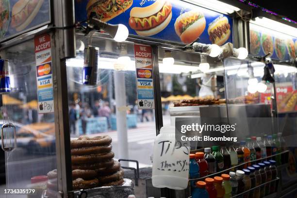 Sticker for American Express, Mastercard, Visa and Discover credit cards displayed on a street cart in New York, US, on Tuesday, Oct. 17, 2023....