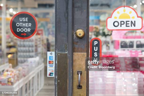 Sticker for American Express, Mastercard, Visa and Discover credit cards displayed at a business in New York, US, on Tuesday, Oct. 17, 2023. American...