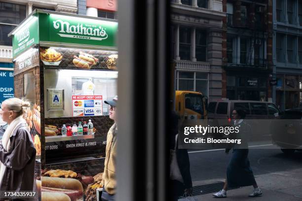 Sticker for American Express, Mastercard, Visa and Discover credit cards displayed on a street cart in New York, US, on Tuesday, Oct. 17, 2023....