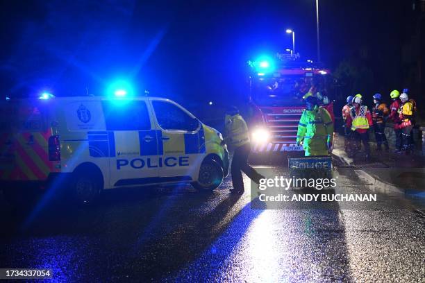 Police officers close the road as members of the coastguard go door to door to evacuate residents along River Street in Brechin on the east of...