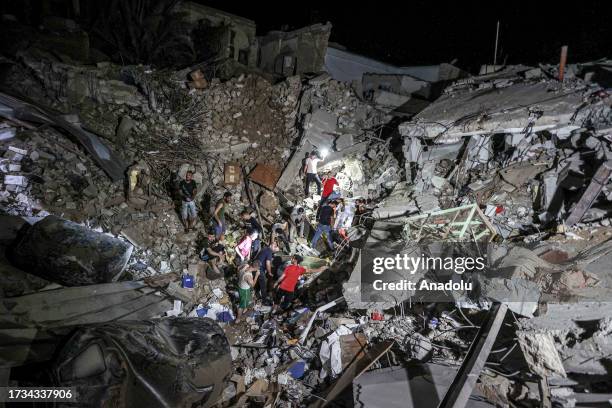 People are seen at the scene of destruction after an Israeli attack on the Greek Orthodox Church in Gaza City, Gaza on October 20, 2023. At least two...