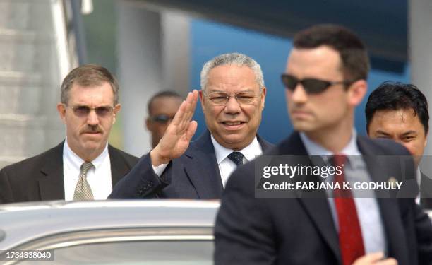 Secretary of State Colin Powell waves upon his arrival at Halim airport in Jakarta, 01 July 2004. Powell arrived 01 July in Indonesia to attend the...