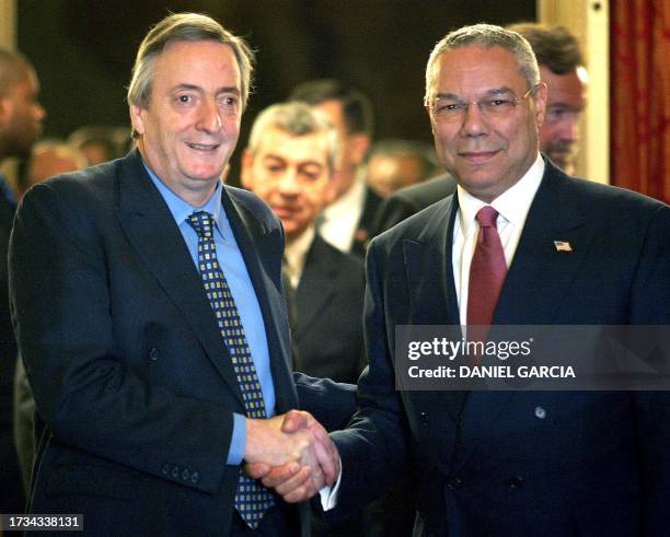 Argentina's President Nestor Kirchner shakes hands with US Secretary of State Colin Powell at the Salon Azul of the Presidential Palace prior to a...