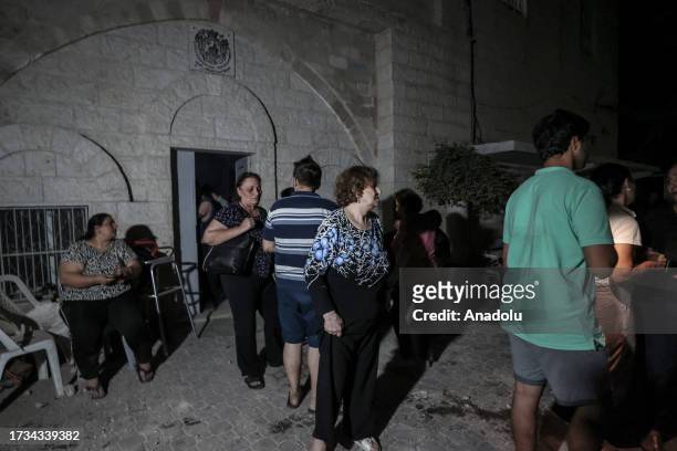 People are seen at the view of destruction after an Israeli attack on the Greek Orthodox Church in Gaza City, Gaza on October 20, 2023. At least two...