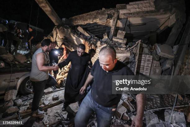 People are seen at the view of destruction after an Israeli attack on the Greek Orthodox Church in Gaza City, Gaza on October 20, 2023. At least two...