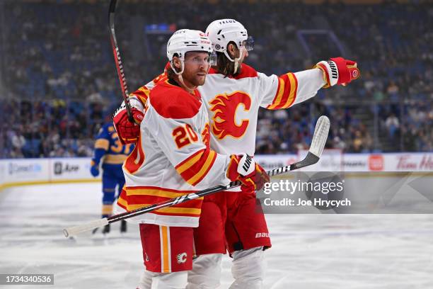 Blake Coleman of the Calgary Flames celebrates his third period goal with Chris Tanev during an NHL game against the Buffalo Sabres on October 19,...
