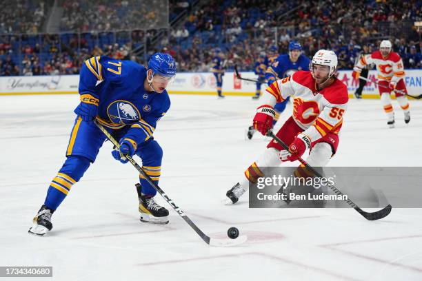 Peterka of the Buffalo Sabres skates with the puck against Noah Hanifin of the Calgary Flames during an NHL game on October 19, 2023 at KeyBank...