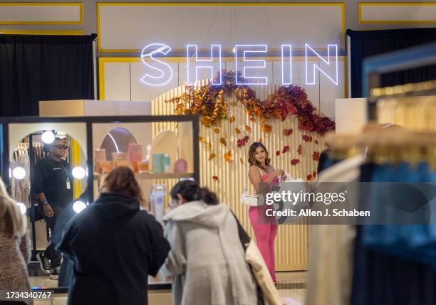 Ontario, CA Shoppers Ashley Sanchez, center, of Fontana, poses for her friend Joscelin Flores, not pictured, who was taking photos with their bags of...