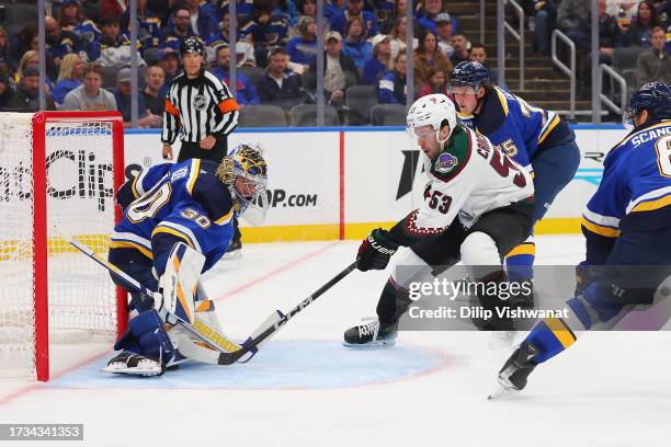 Michael Carcone of the Arizona Coyotes shoots the puck against Joel Hofer of the St. Louis Blues during the second period at Enterprise Center on...