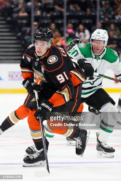 Leo Carlsson of the Anaheim Ducks skates with the puck with pressure from Ryan Suter of the Dallas Stars during the first period Honda Center on...