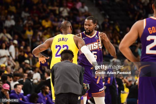 LeBron James of the Los Angeles Lakers and Kevin Durant of the Phoenix Suns embrace before the game on October 19, 2023 at the Acrisure Arena in Palm...