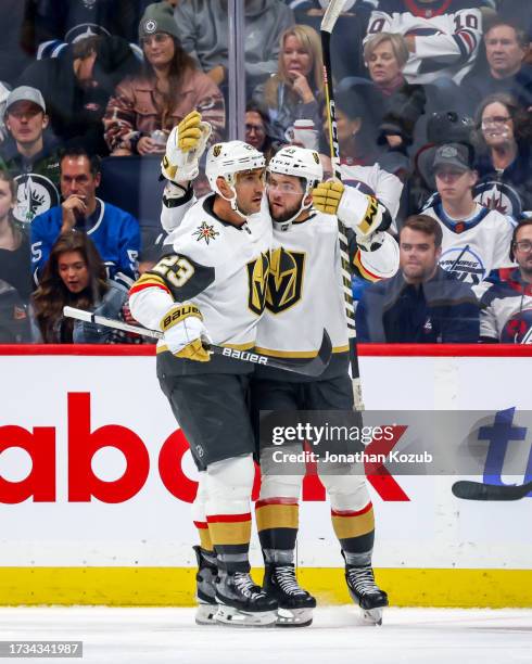 Alec Martinez and Paul Cotter of the Vegas Golden Knights celebrate a second period goal against the Winnipeg Jets at the Canada Life Centre on...