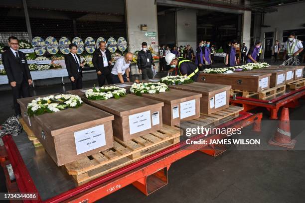 Coffins of 8 Thai workers killed in the conflict between Israel and Palestinian militant group Hamas are displayed after being repatriated from...