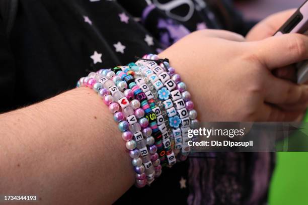 Fan wears friendship bracelets before attending the opening night theatrical release of "Taylor Swift: The Eras Tour" concert movie at AMC Empire 25...