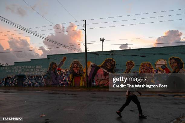 Man walks past a mural displayed on a building along Myrtle Avenue on Thursday, September 21, 2023 in Jacksonville, Florida. Some Jacksonville...