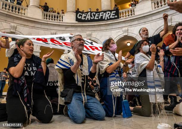 Large group gathers in the rotunda of the Cannon House Office Building to stage a sit down strike as Jewish Voice for Peace holds a large rally and...
