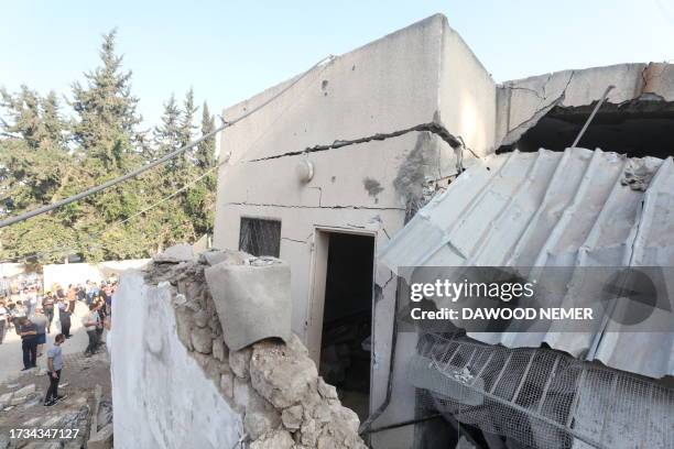 People gather the day after the Greek Orthodox Saint Porphyrius Church, the oldest church still in use in Gaza, was damaged in a strike on Gaza City...