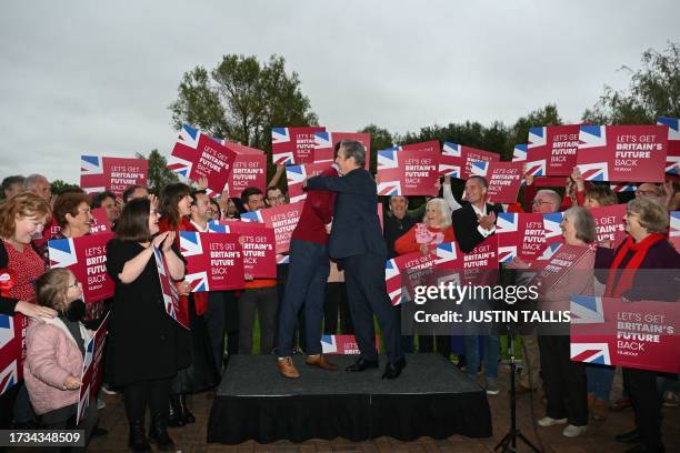 Britain's main opposition Labour Party leader Keir Starmer hugs newly elected Labour MP Alistair Strathern as they celebrate in Bedford after winning...