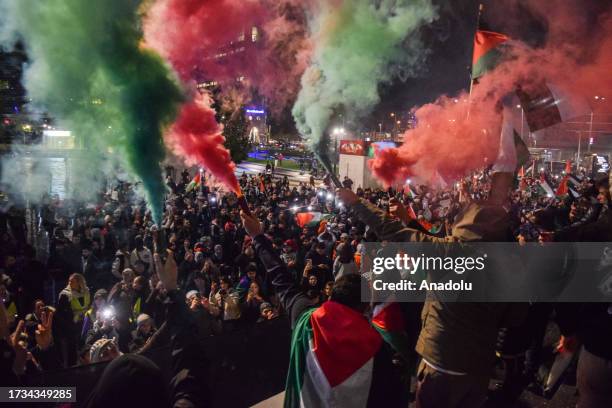 Smoke with the colors of Palestinian flag rises as thousands of people participate in a march under the theme 'Together for Gaza', starting from Dam...