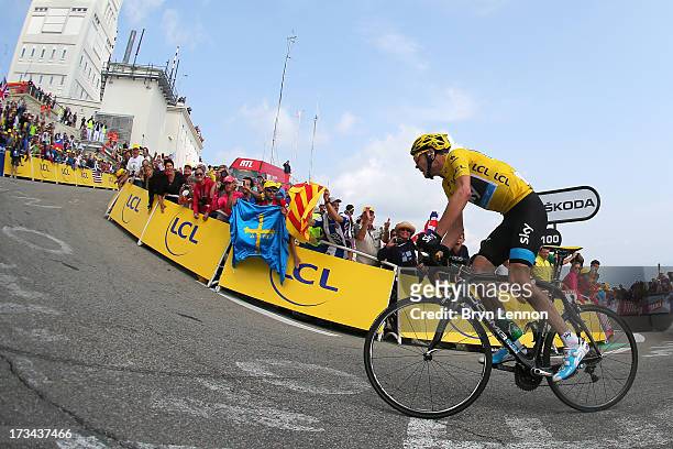Current race leader and wearer of the Maillot Jaune, Chris Froome of Great Britain and SKY Procycling attacks to win the stage during stage fifteen...