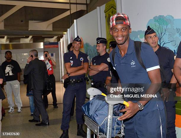 Under-20 French team midfielder Mario Lemina arrives with teammates at the Roissy-Charles-de-Gaulle airport, on July 14 a day after defeating Uruguay...