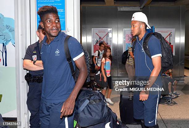 Under-20 French team defenders Samuel Umtiti and Pierre-Yves Polomat arrive with teammates at the Roissy-Charles-de-Gaulle airport, on July 14 a day...