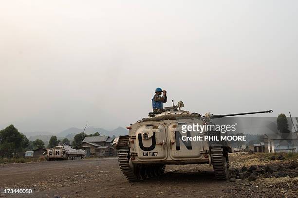 An Indian United Nations peacekeeper looks through binoculars towards M23 positions in Kanyarucinya on the outskirts of Goma in the east of the...