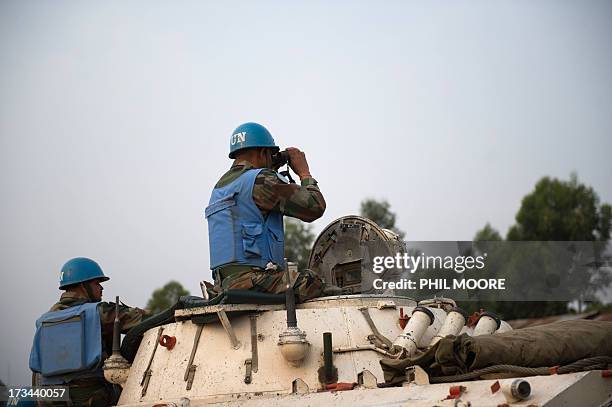 An Indian United Nations peacekeeper looks through binoculars towards M23 positions in Kanyarucinya on the outskirts of Goma in the east of the...