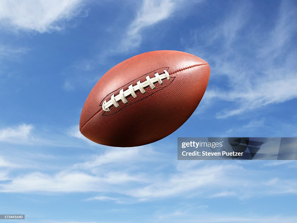 American football flying mid-air