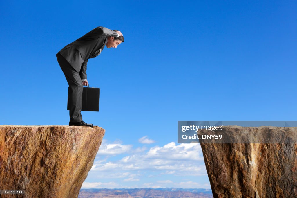 Man in a suit stares at space between two ledges